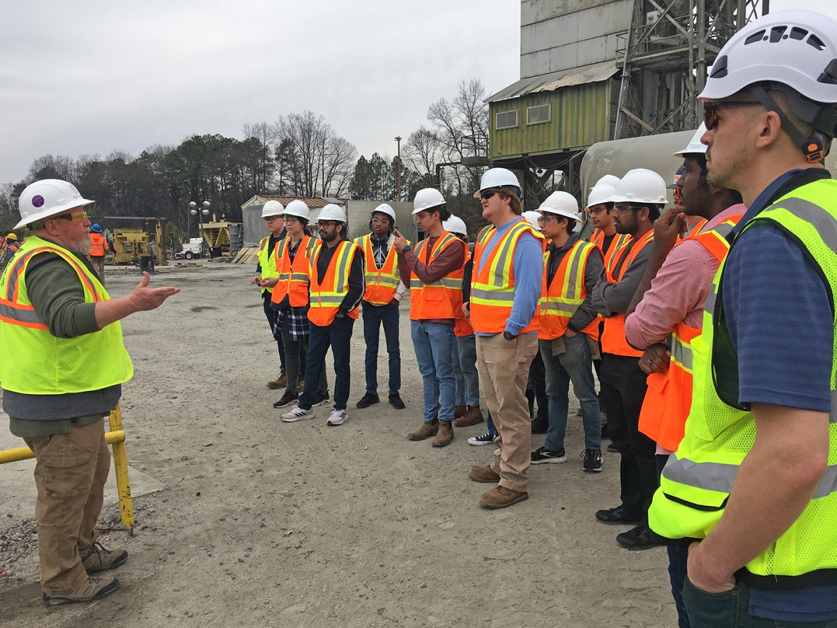 Chief engineer Fletcher Smith of Standard Concrete Products addresses a group of students in protective gear