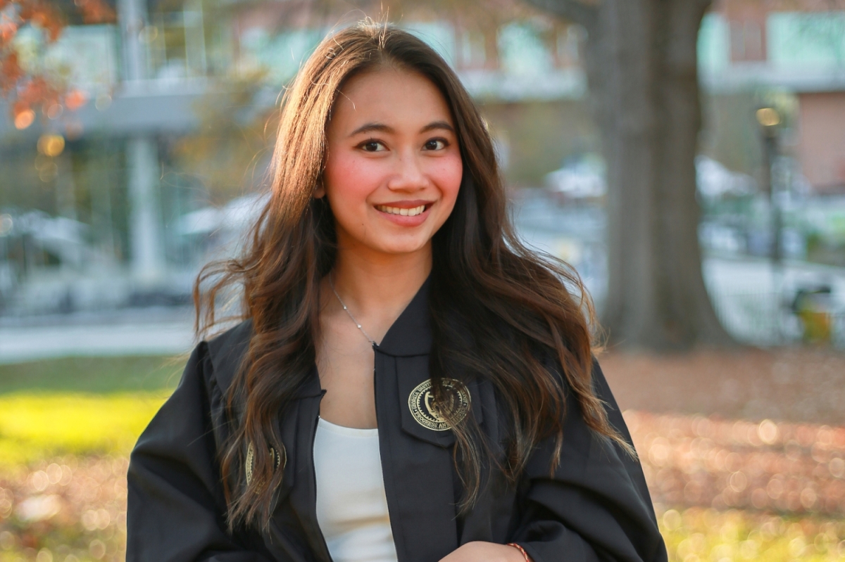 A portrait of a woman in a graduation robe