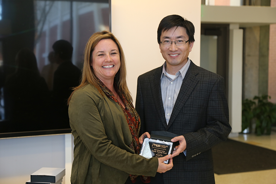 Sheng Dai receives his award from Interim School Chair Kimberly Kurtis. (Photo: Jess Hunt-Ralston)