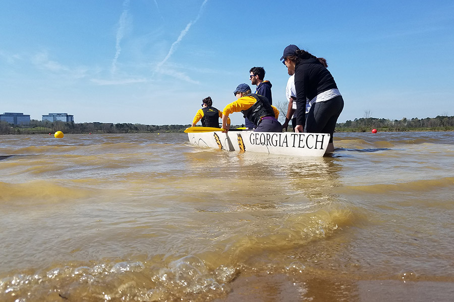 The ASCE concrete canoe team launches their vessel for the women’s sprint race, where chapter president Caroline Stanton and conference chair Alesa Stallman placed second after winning their heat. (Photo: Vy Le)