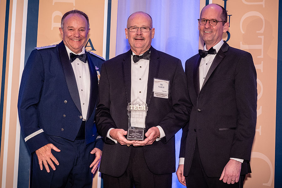Alumnus Isaac "Ike" Scott, center, was inducted into the Georgia Tech College of Engineering Academy of Distinguished Engineering Alumni April 21. He's holding his award alongside the ceremony's guest speaker, retired Gen. Philip Breedlove, left, and engineering Dean Steve McLaughlin. (Photo: Gary Meek)
