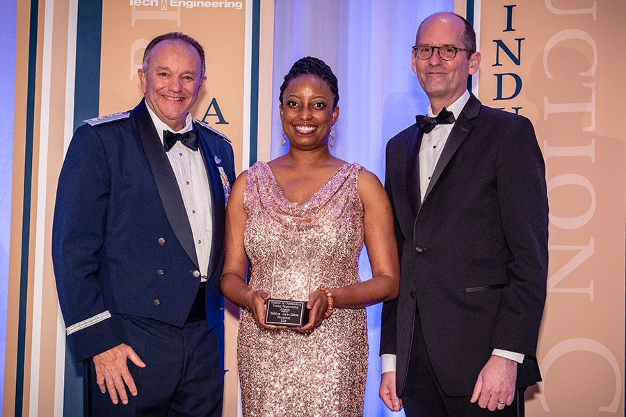 Alumna Zakiya Seymour, center, was inducted into the Georgia Tech College of Engineering Council of Outstanding Young Engineering Alumni April 21. She's holding her award alongside the ceremony's guest speaker, retired Gen. Philip Breedlove, left, and engineering Dean Steve McLaughlin. (Photo: Gary Meek)