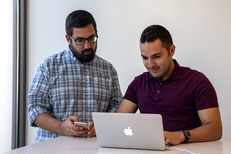 Fikret Atalay, left, and Mahdi Roozbahani work on their image management app Filio, which went live June 24. The web and mobile app allows contractors, insurance companies and other businesses to take photos at a worksite and instantly caption and catalog those images. The app captures GPS coordinates and the direction the camera was pointing and uses a voice-to-text function to allow users to describe the photo and why they took it. Atalay and Roozbahani developed the app while they were Ph.D. students in the School of Civil and Environmental Engineering, including participating in Georgia Tech's CREATE-X program to help students turn their ideas into startup ventures. The co-founders both finished their doctoral work in the spring and are working to turn Filio into their full-time occupation. (Photo: Amelia Neumeister)