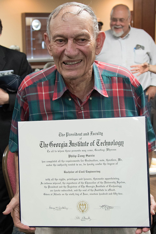Philip Sarris holds the diploma he earned in 1952 but never actually received. (Photo: Scott Dinerman)