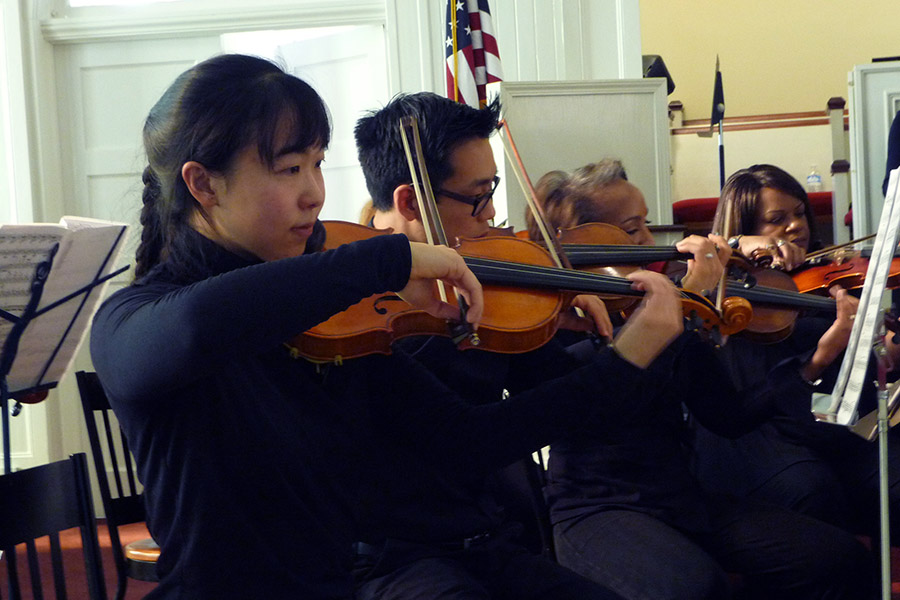 Iris Tien playing violin with the Atlanta Musicians Orchestra along with several other musicians. (Photo Courtesy: Iris Tien)