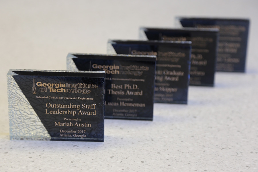 A row of awards plaques presented to students, faculty and staff at the 2017 CEE Awards Ceremony Dec. 11. (Photo: Jess Hunt-Ralston)