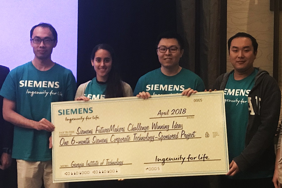 Civil engineering students Yang Jiang, Emily Sanders and Heng Chi plus computation science and engineering student Yuyu Zhang with their first-place check after the Siemens FutureMakers Challlenge. Their concept for the hackathon at Georgia Tech combined machine learning and topology optimization to make computational design and digital manufacturing more efficient and effective. (Photo Courtesy: Glaucio Paulino)